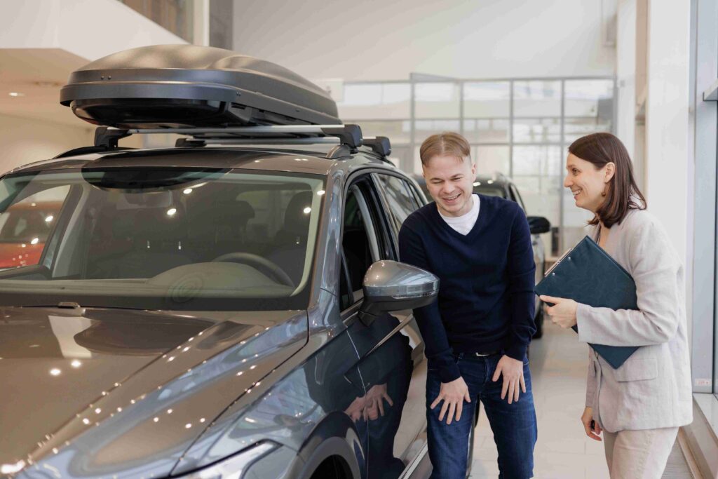 man-buys-a-car-at-a-car-dealership-a-female-sales-2022-10-05-21-22-56-utc (1)