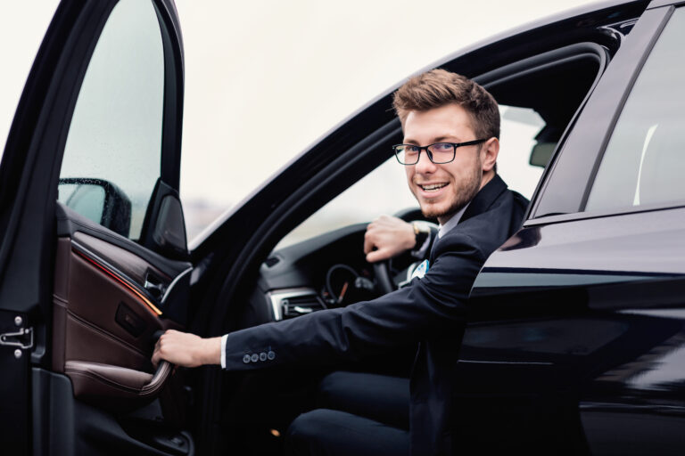 Young businessman driving alone in his luxury car