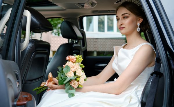 Bride sits in the car